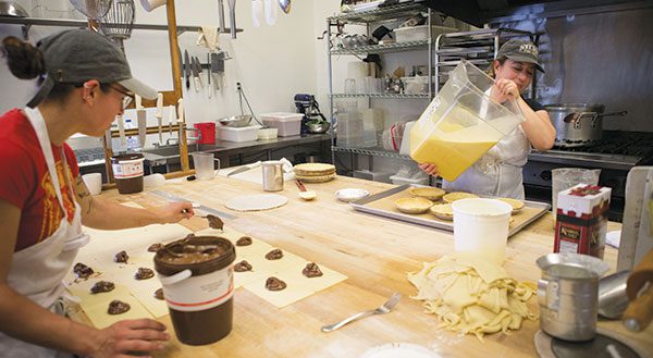 Kelsey Smith (left) and Sarah Vegas prepare Nutella PopTarts and Vanilla Buttermilk Custard Pies for lucky Niles Pie customers